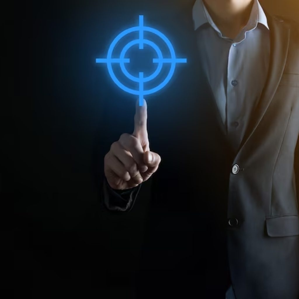 targeting-concept-with-businessman-hand-holding-target-icon-dartboard-sketch-chalkboard-objective-ta